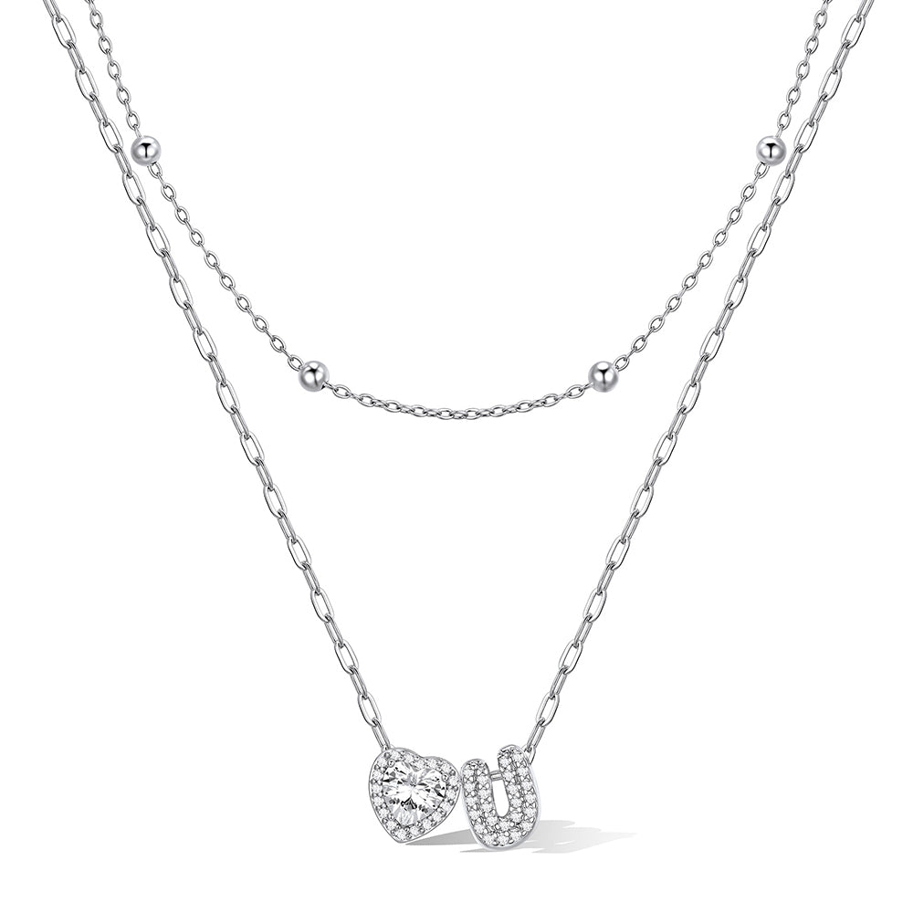 Silver cz bubble initial U necklace with a heart-shaped pendant on a white background