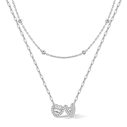 Silver cz bubble initial V necklace with a heart-shaped pendant on a white background