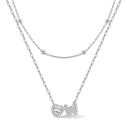 Silver cz bubble initial W necklace with a heart-shaped pendant on a white background