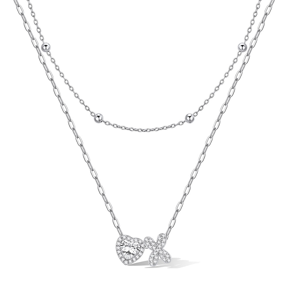 Silver cz bubble initial x necklace with a heart-shaped pendant on a white background