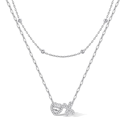 Silver cz bubble initial x necklace with a heart-shaped pendant on a white background