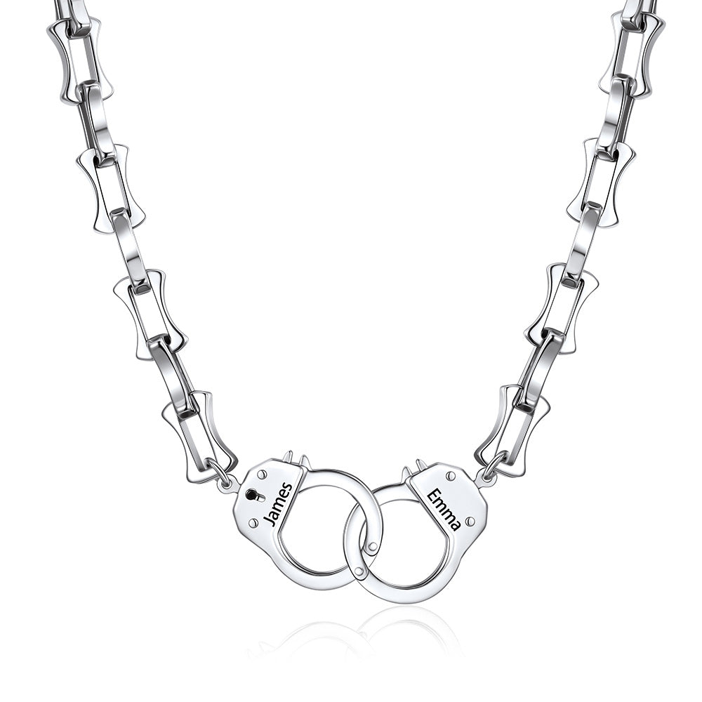 Silver handcuff bamboo link necklace with handcuff pendants engraved with names on a white background