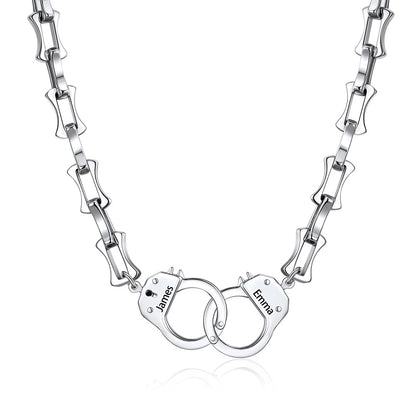 Silver handcuff bamboo link necklace with handcuff pendants engraved with names on a white background