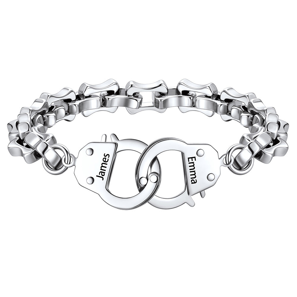Silver handcuff bracelet with interlocking heart charms engraved with names on a white background