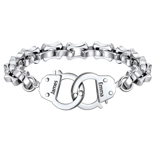 Silver handcuff bracelet with interlocking heart charms engraved with names on a white background