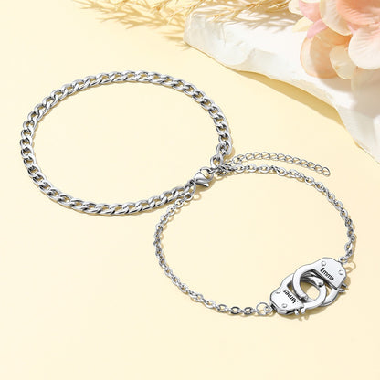 Silver handcuff chain ankle bracelet on a light yellow background