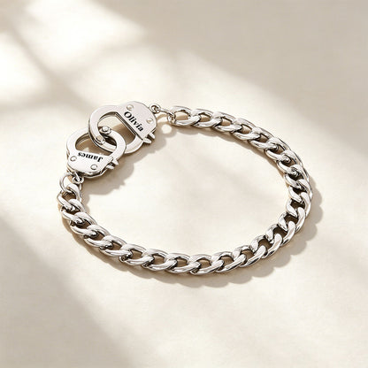 Silver handcuff chain bracelet with a clasp on a light background
