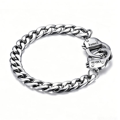 Silver handcuff chain bracelet with a clasp on a white background