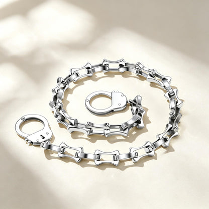 Silver handcuffs bamboo chain necklace engraved names on a beige background