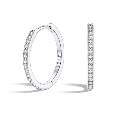 Silver huggie earrings with embedded stones on a white background