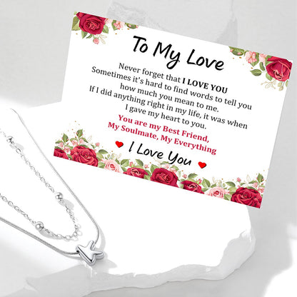 Silver initial necklace with a sentimental card featuring red roses and romantic text on a white background