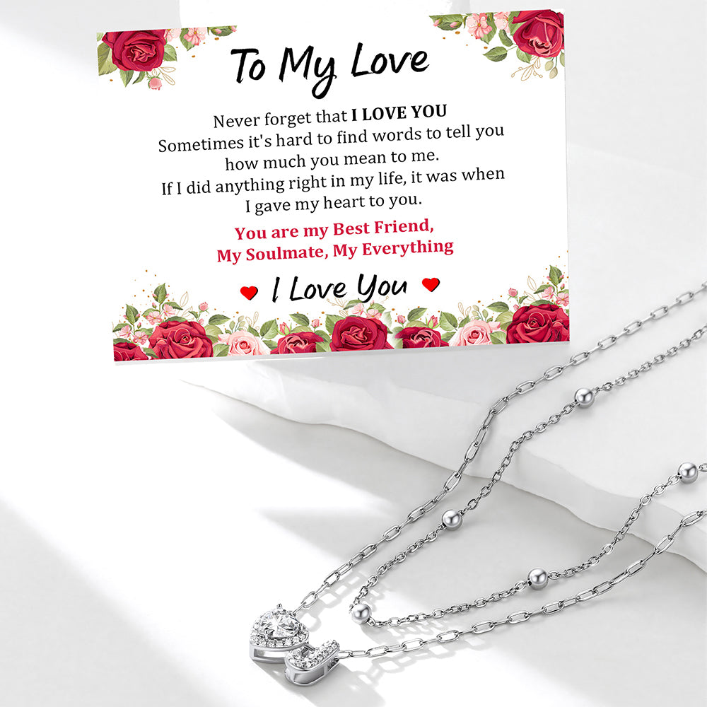 Silver initial necklace with a sentimental card on a white background