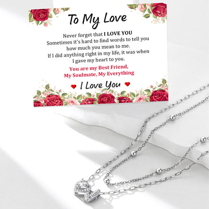 Silver initial necklace with a sentimental card on a white background