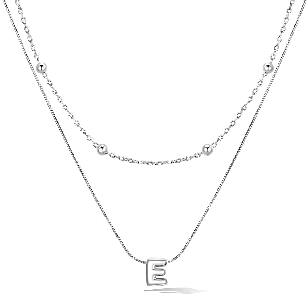 Silver layered initial E necklace, showing measurements and material details.