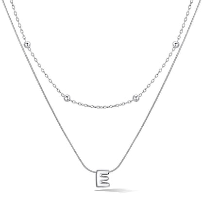 Silver layered initial E necklace, showing measurements and material details.