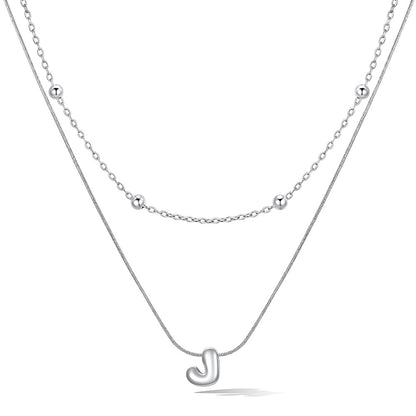 Silver layered initial J necklace, showing measurements and material details.