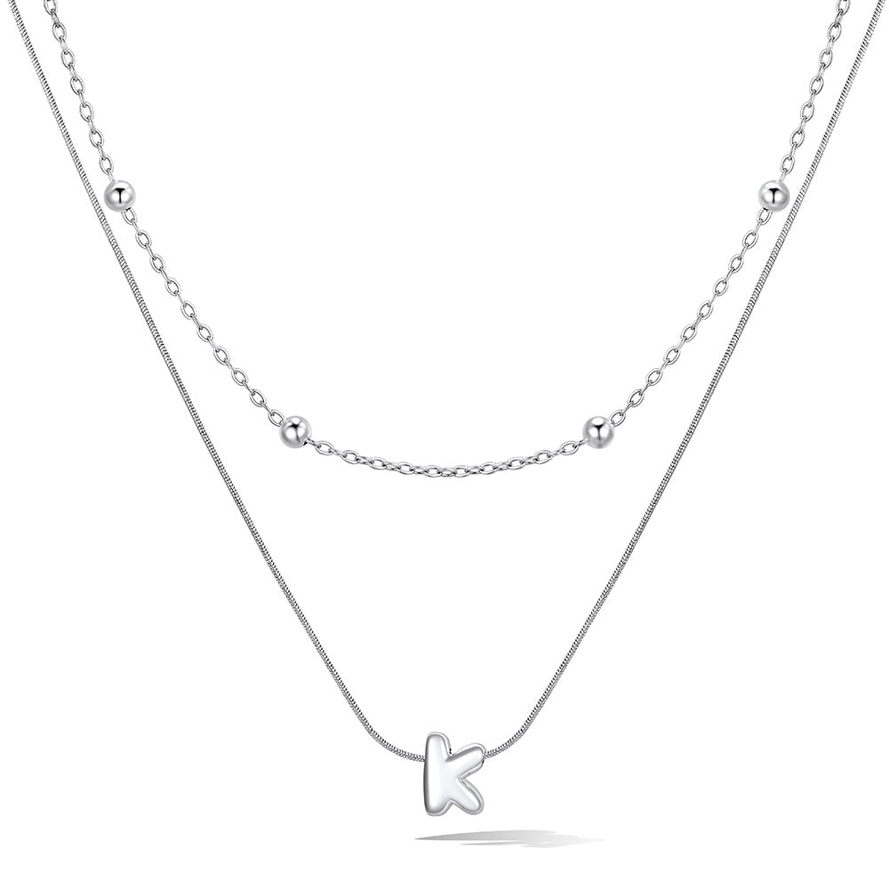 Silver layered initial K necklace, showing measurements and material details.
