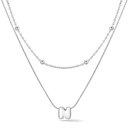 Silver layered initial N necklace, showing measurements and material details.
