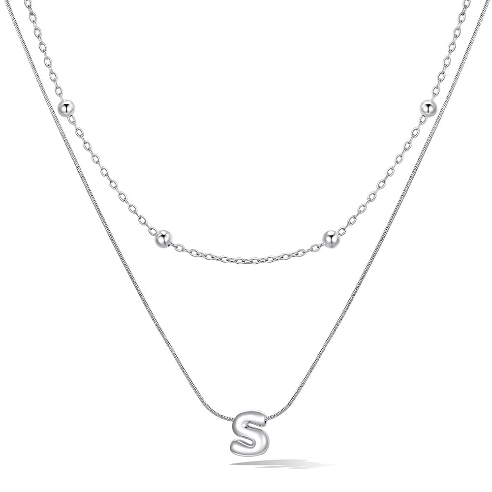 Silver layered initial S necklace, showing measurements and material details.