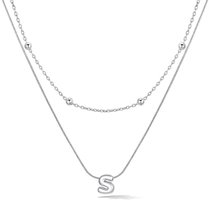 Silver layered initial S necklace, showing measurements and material details.