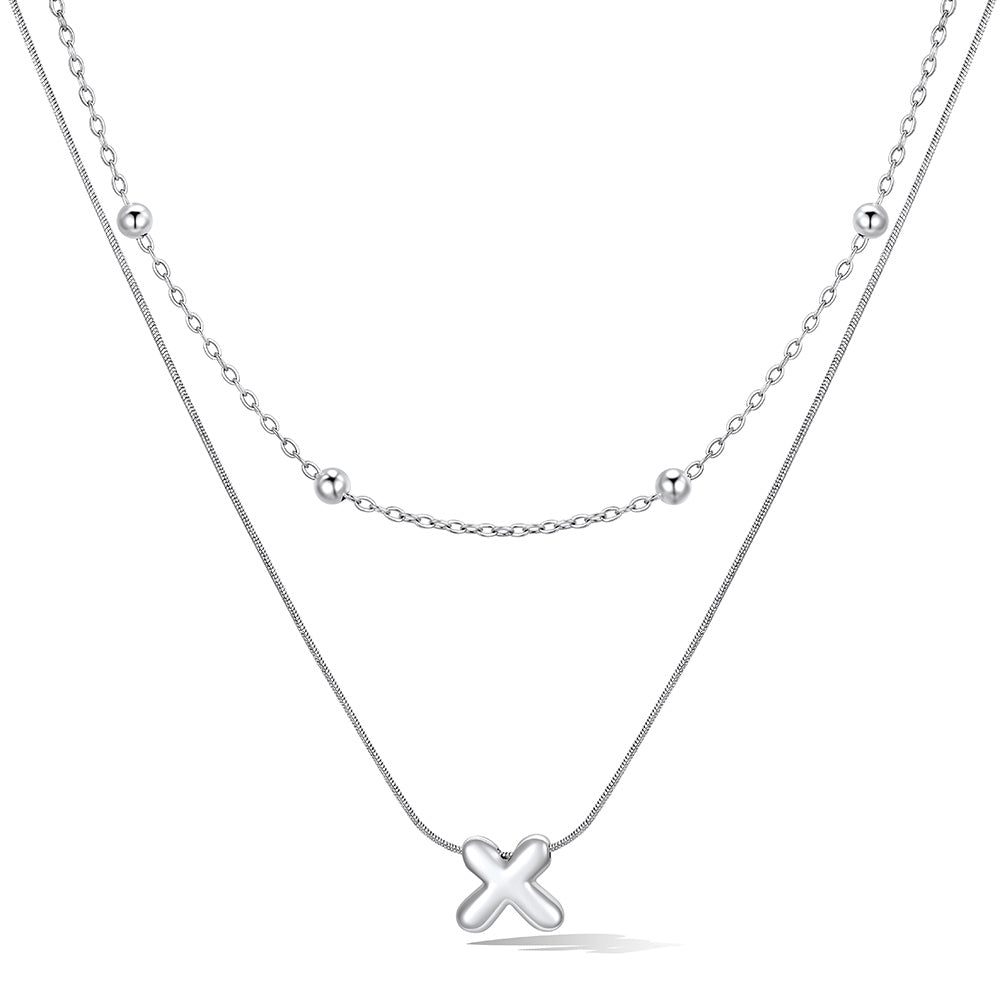 Silver layered initial X necklace, showing measurements and material details.