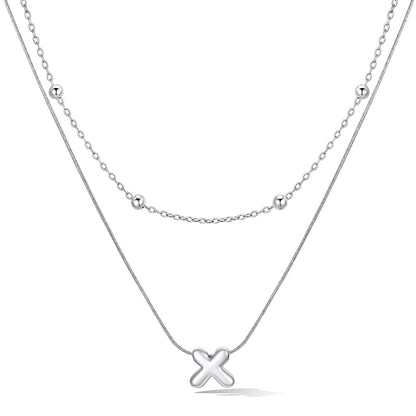 Silver layered initial X necklace, showing measurements and material details.