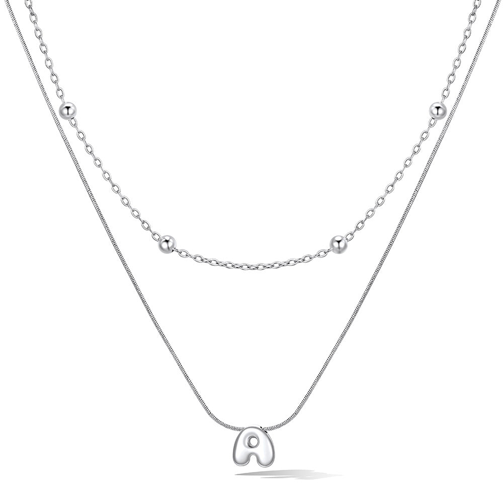 Silver layered initial a necklace, showing measurements and material details.