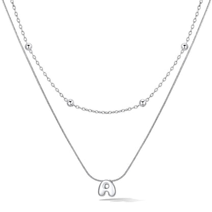 Silver layered initial a necklace, showing measurements and material details.