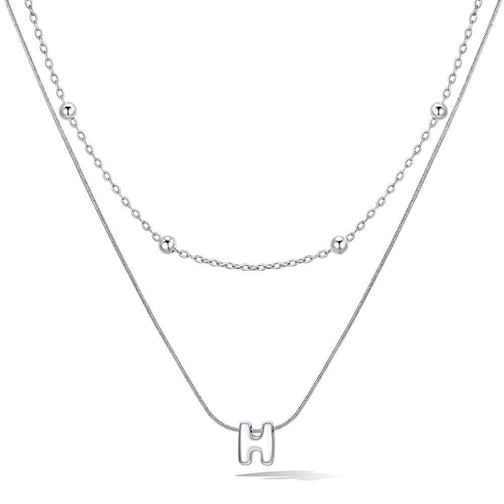 Silver layered initial h necklace, showing measurements and material details.