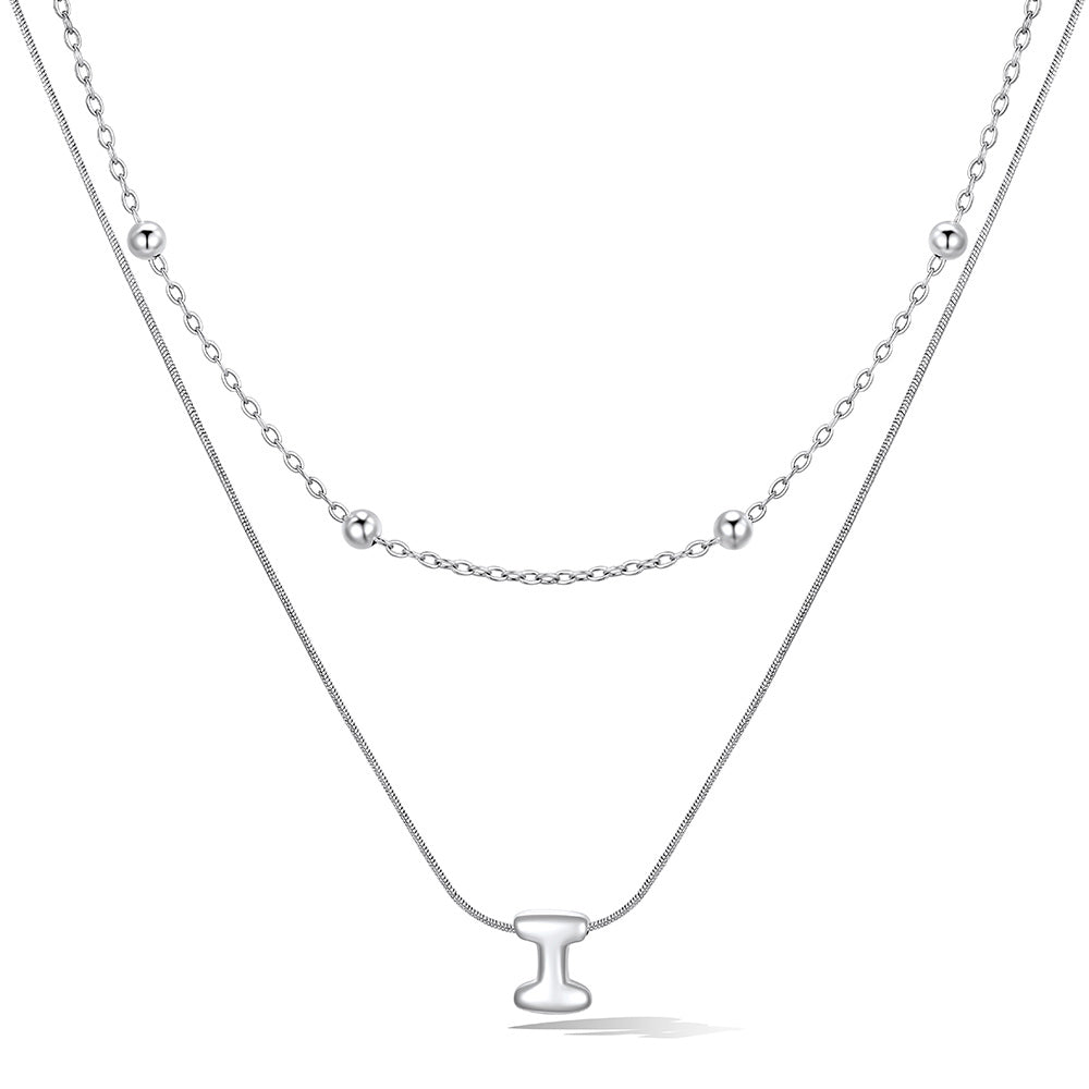 Silver layered initial i necklace, showing measurements and material details.