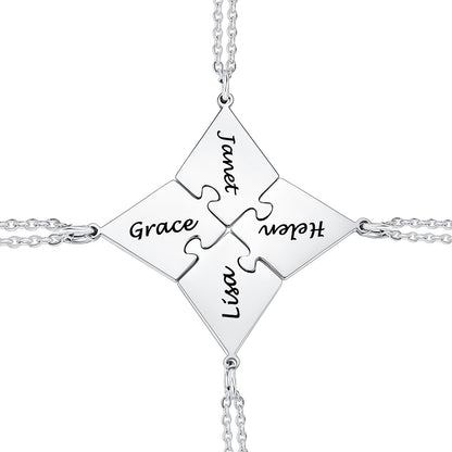 Silver matching puzzle necklace with puzzle piece pendants engraved with names on a white background