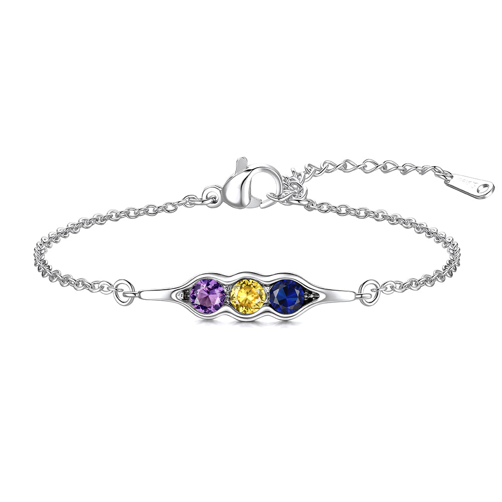 Silver pea in pot bracelet with three colored gemstones on a white background