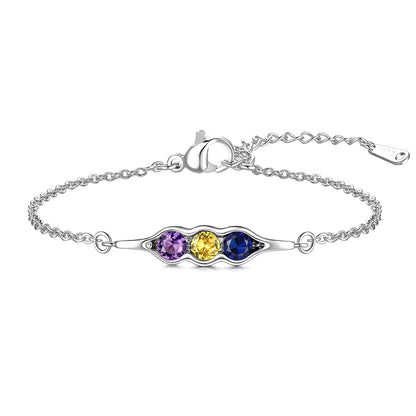 Silver pea in pot bracelet with three colored gemstones on a white background