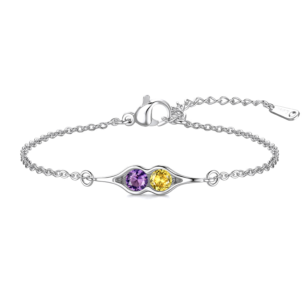 Silver pea in pot bracelet with two colored stones on a white background