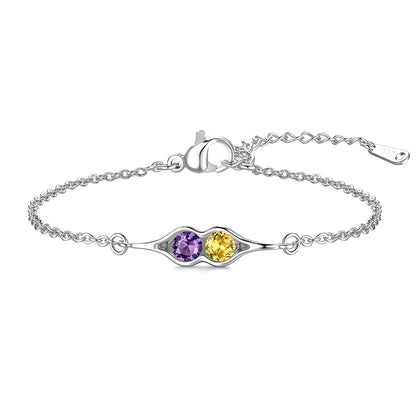 Silver pea in pot bracelet with two colored stones on a white background