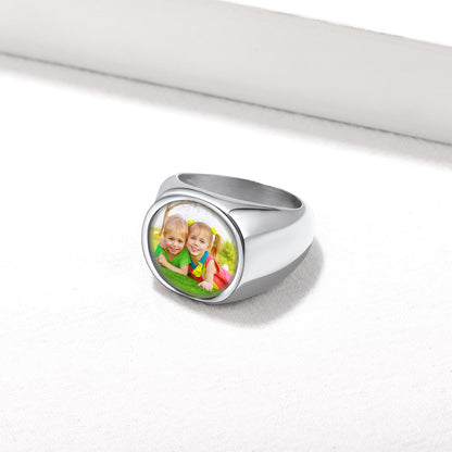 Silver personalized signet ring with a photo of two children on a white background