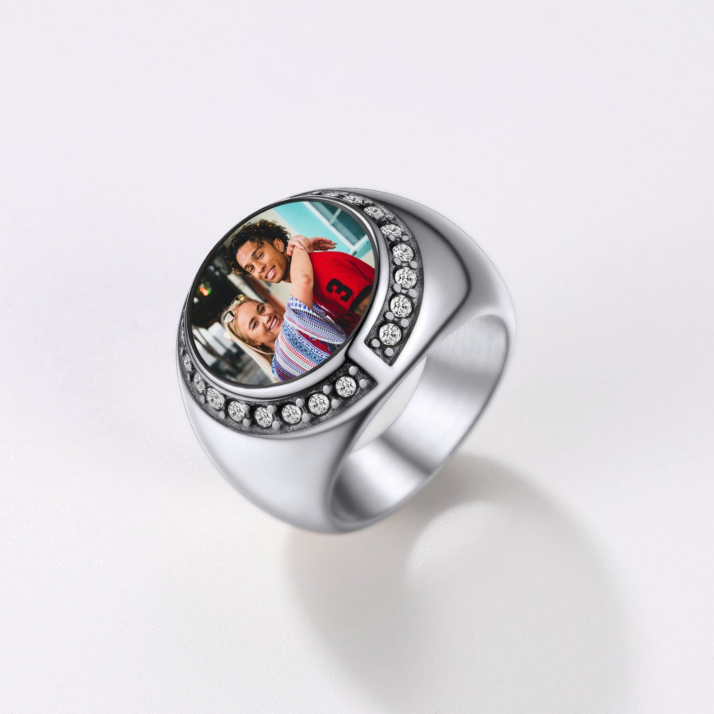 Silver picture signet ring with a round photo insert on a white background