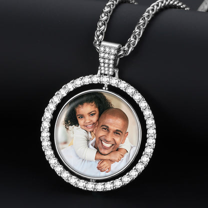 Silver rotatable picutre necklace with a round pendant featuring a photo of a man and a child on a black background