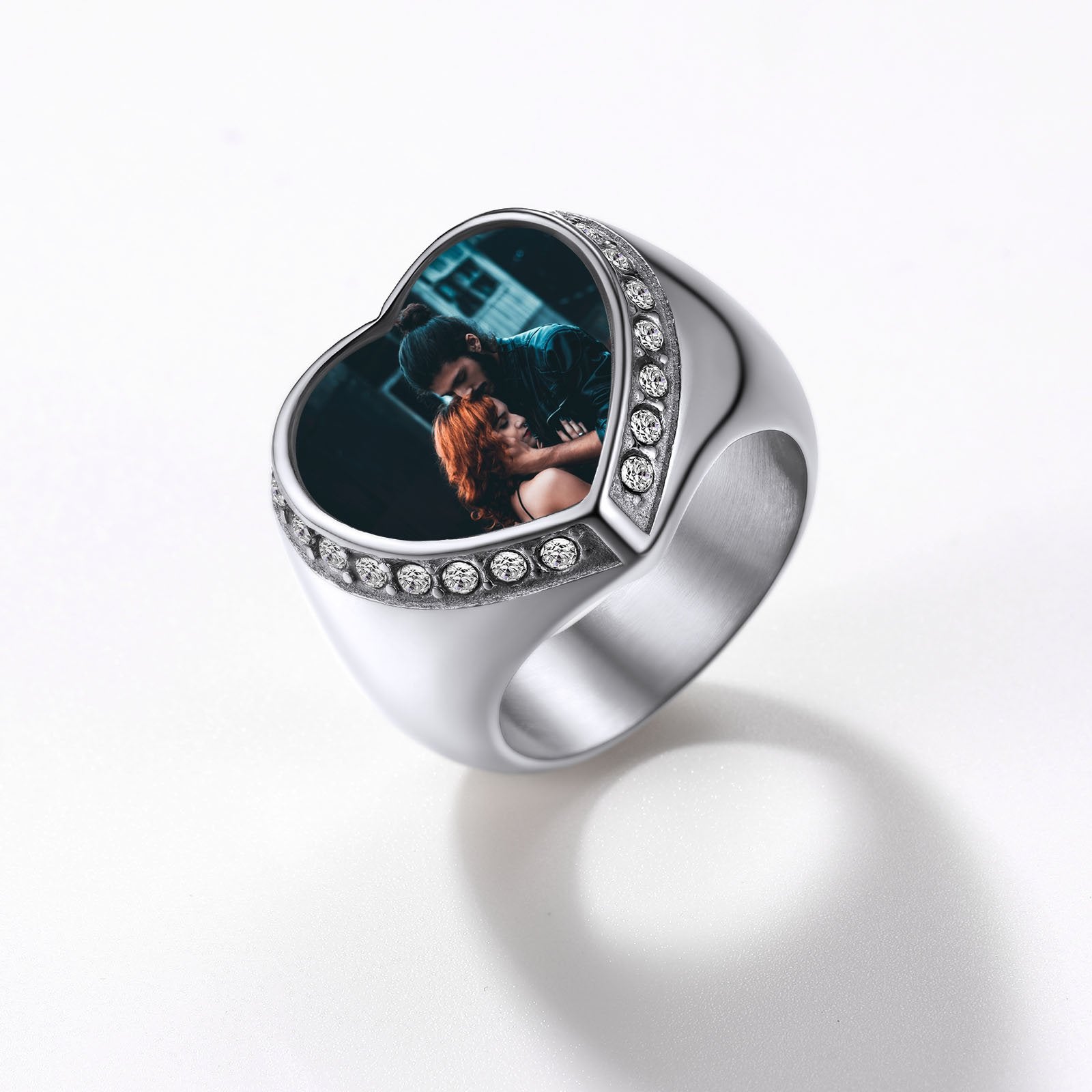 Silver signet ring with a heart-shaped photo insert on a white background