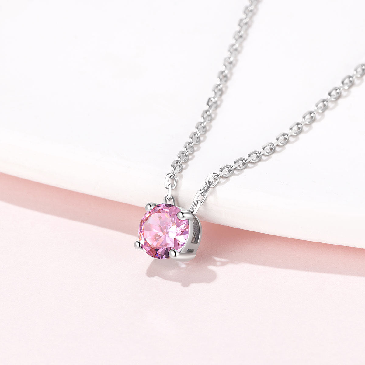 Solitaire Birthstone October Necklace on a pink background