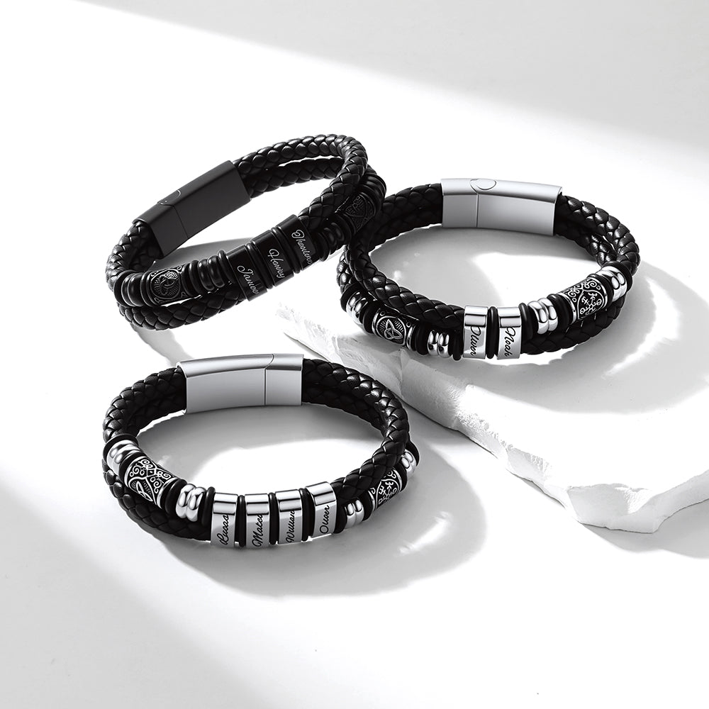 Three Viking Custom Name leather bracelets with metal accents on a white background