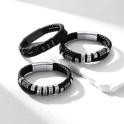 Three Viking Custom Name leather bracelets with metal accents on a white background