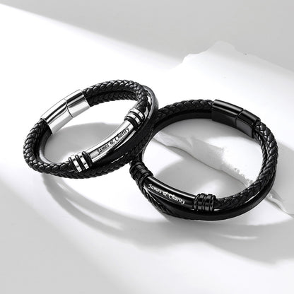 Two black braided rope engraved bracelets with polished silver metal accents and the engraved text 'Justice and Charity', displayed on a clean white background.