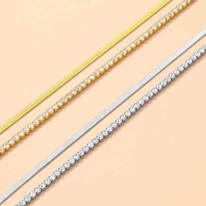 Two gold and two silver anklet set on a beige background