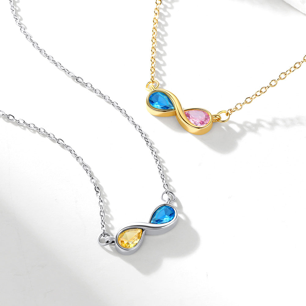 Two infinity birthstone necklaces with colorful gemstones on a white background