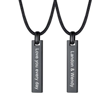 Two matching black rectangular engraved bar necklaces on black cords, shown against a plain white background. One pendant reads 'Love you every day' and the other reads 'Landon & Wendy'.
