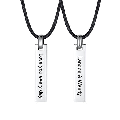Two matching silver bar pendant necklaces on black cords, shown against a white background. One pendant is engraved with 'Love you every day' and the other with 'Landon & Wendy'.