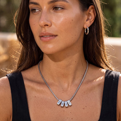 Woman wearing a multi namenecklace with pendant names outdoors