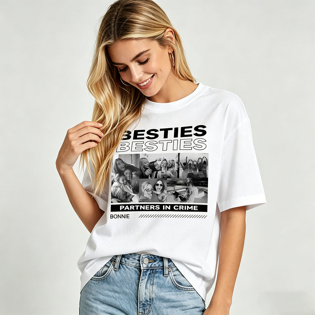 Woman wearing a white besties t-shirt with a graphic design and text on a plain background
