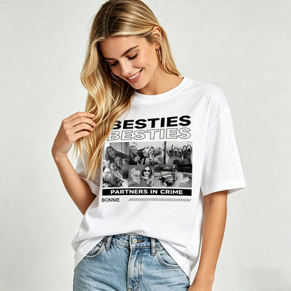 Woman wearing a white besties t-shirt with a graphic design and text on a plain background